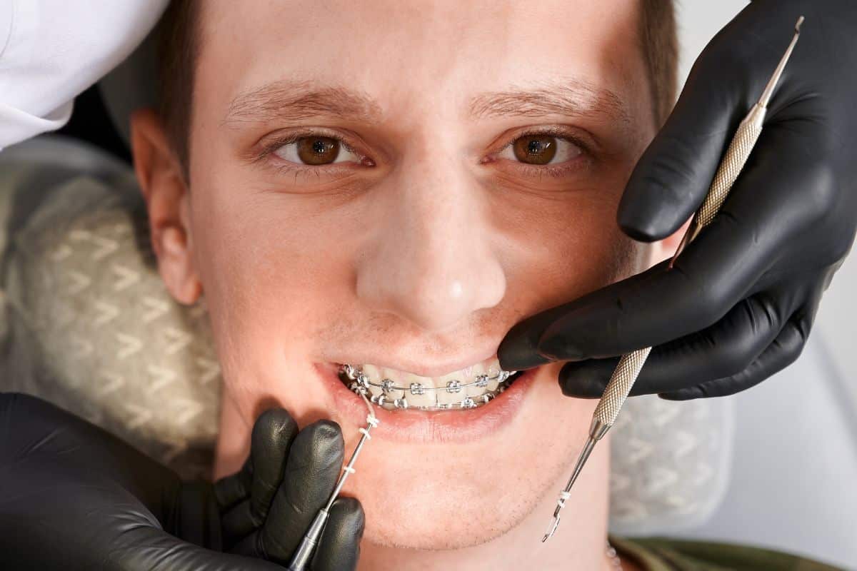 Orthodontist examining a patient’s braces during a dental appointment in Southlake, Texas.